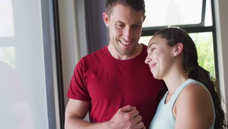 Happy-caucasian-couple-talking-and-looking-out-the-window