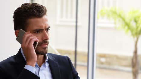 businessman talking on mobile phone at desk 4k