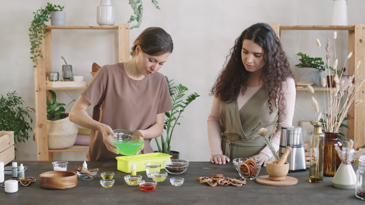 Woman Pouring DIY Soap Mixture In Mold