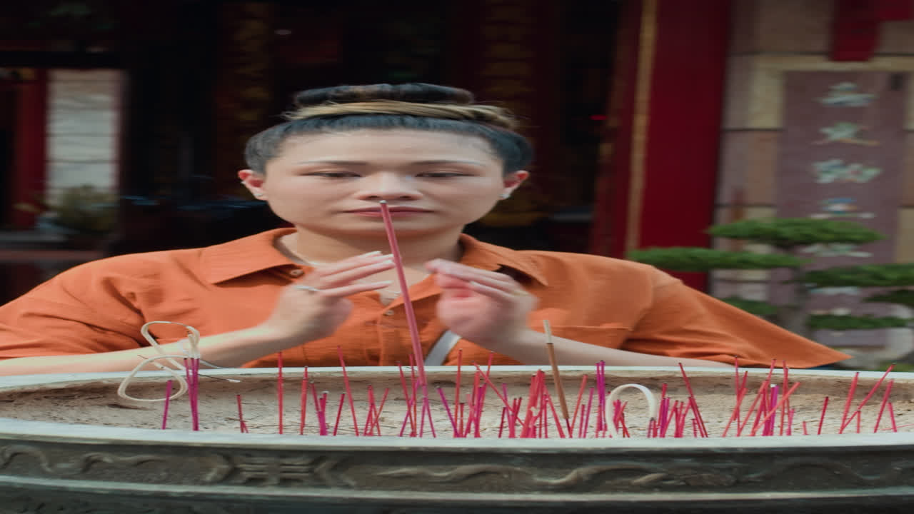Woman Praying by Altar with Burning Candles