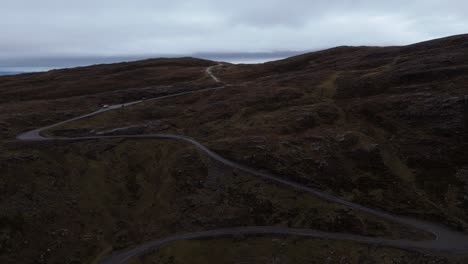 aerial view of a winding mountain road in scotland