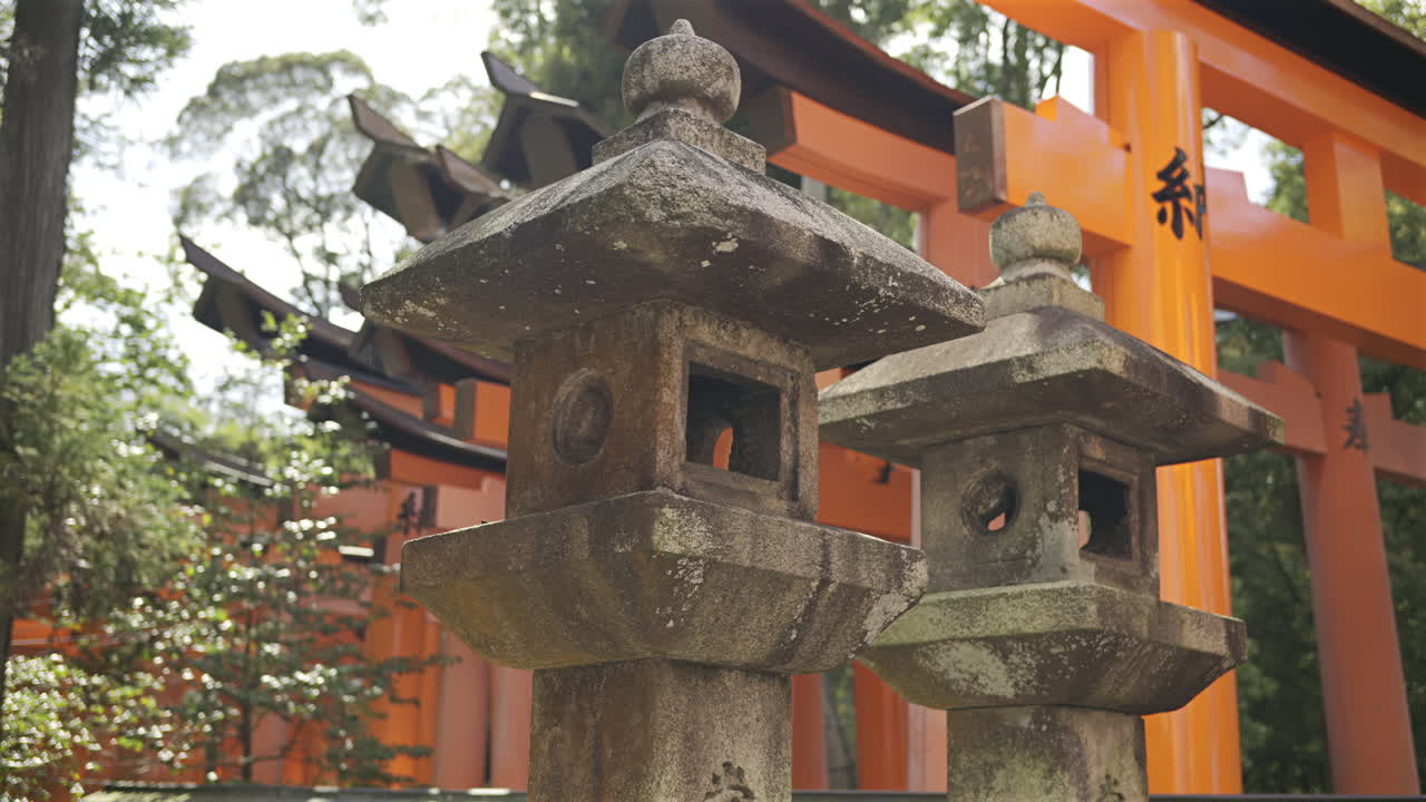 A vibrant red torii gate stands majestically among the trees, symbolizing the entrance to a sacred area. Religious text in Japanese written on the gate