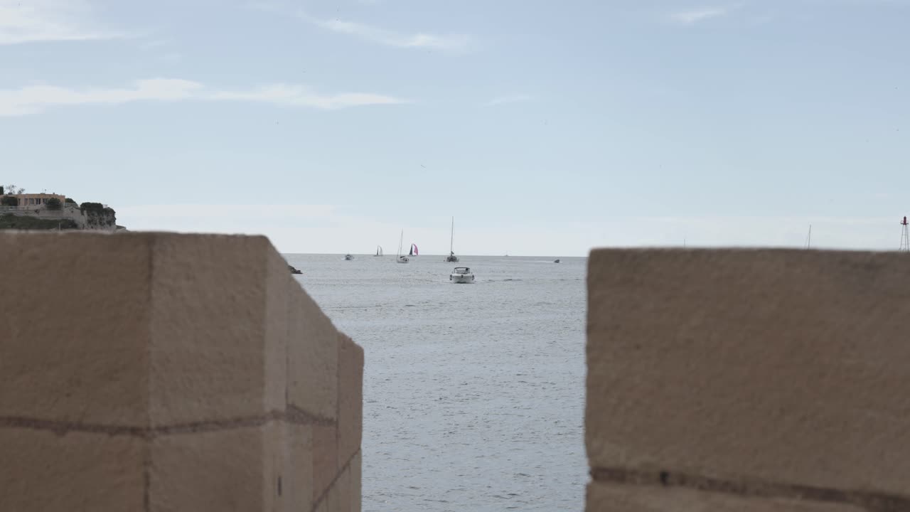 Sea and boats seen through wall at Prom. Louis Brauquier, Marseille France