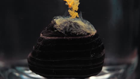 slowmotion paint floating inside water tank, beautiful layered rock. stable shot with the sony a7iii.