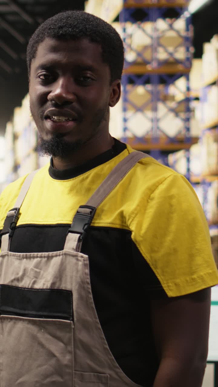 Vertical Video Warehouse worker inspecting cargo on racks in a large scale fulfillment center