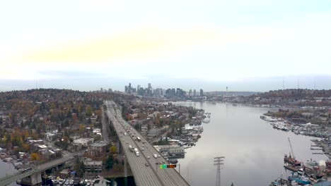 establishing aerial shot of an overcast seattle skyline with traffic passing underneath