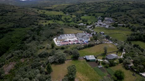 Aerial-drone-footage-flying-over-small-neighborhood-buildings-in-a-lush-mountain-range