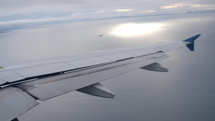 De-banking Airplane in Flight, Passenger View of Aircraft Wing