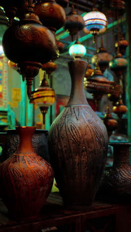 ornate pottery vases and hanging lamps in a middle eastern market