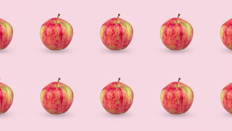dos líneas de manzanas rojas frescas animadas en un fondo rosa o pastel. patrón de bucle sin costuras con comida 3d realista. arte de diseño de movimiento minimalista con frutas