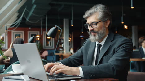 businessman working on laptop in a cafe
