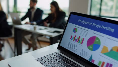 business meeting with data presentation on laptop