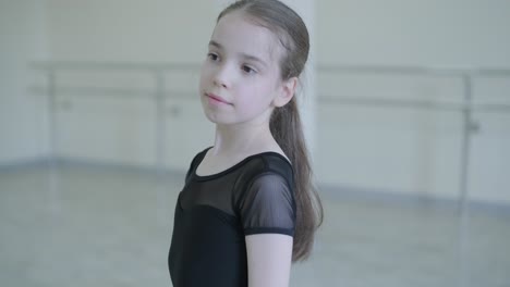 young ballerina practicing dance moves in studio