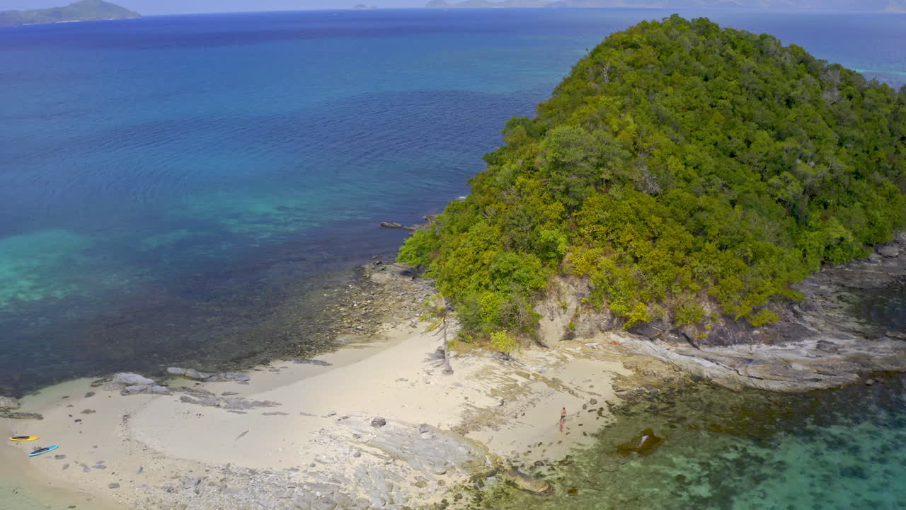 Aerial View of a Pristine Tropical Island Beach with Clear Waters