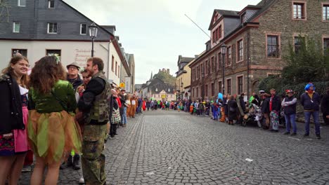 crowd of costumed german people waiting for the street parade on rose monday carnival