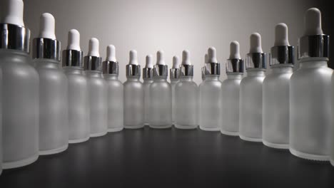 a neat arrangement of frosted glass dropper bottles