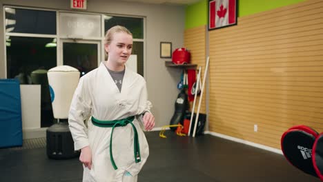 a young teenage girl gets hyped psyched up to double kick jump spar with martial arts taekwondo black belt master in training at a canadian karate gym practice center