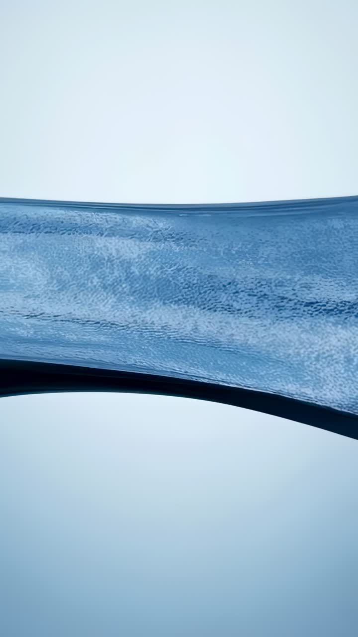 Vertical video: Advancing frames, flowing blue ribbon sliding across pale gradient, showing ripples