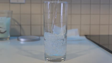 pouring water into a class in slow motion