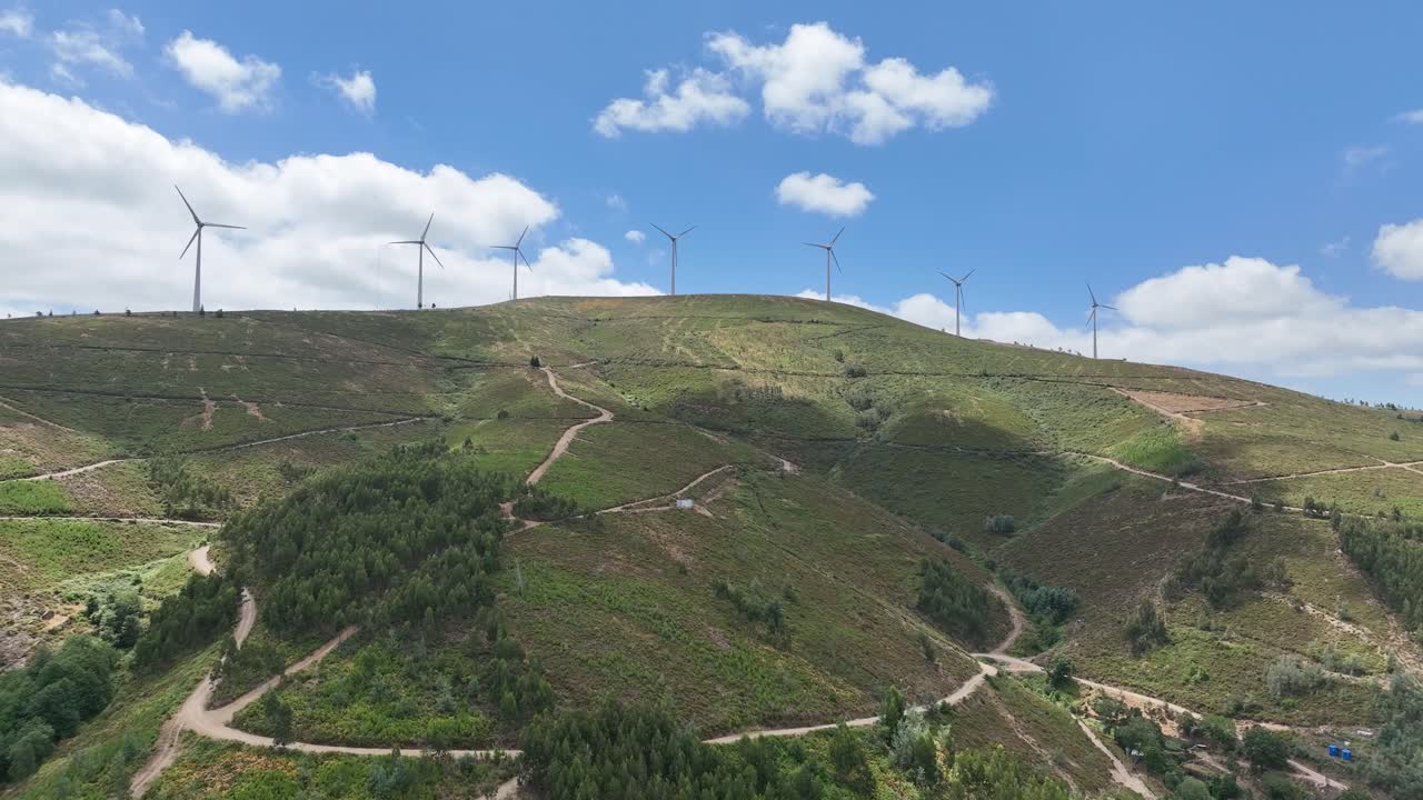 Rotating wind turbines on a hill in Portugal.