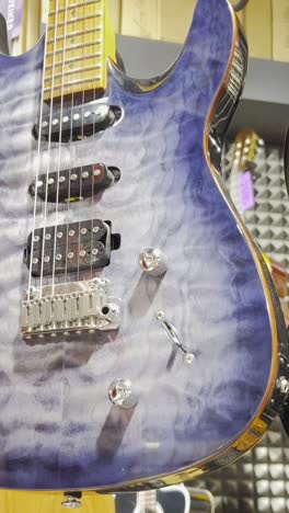 a store of electric guitars of various colors. concept of musical instruments.