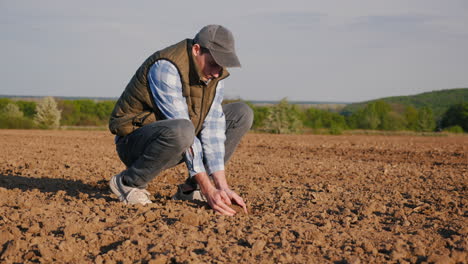 farmer planting seeds in field