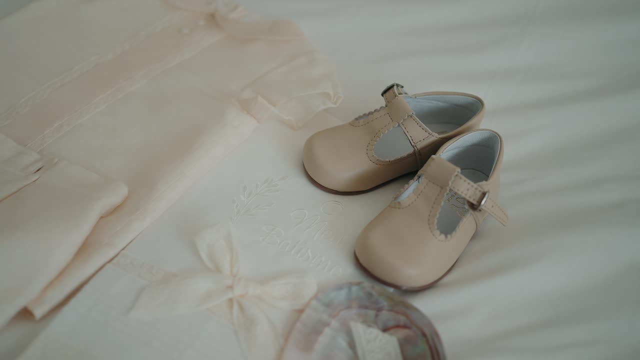 Charming baby shoes resting on soft white fabric