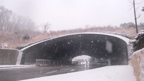 snow falls as cars drive on the highway for a christmas holiday in seoul