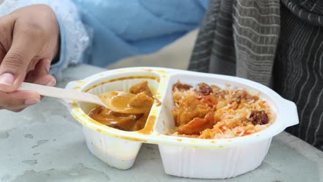 person enjoying delicious curry and biryani