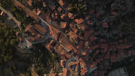 Aerial-top-down-orbit-over-roofs-of-Monsanto-village,-Portugal