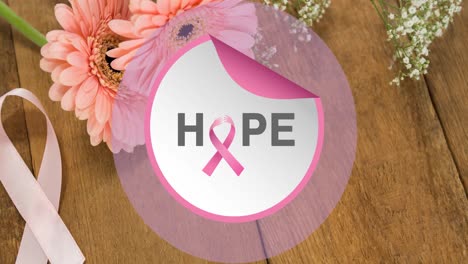 Animation-of-hope-and-pink-ribbon-in-circle-over-table-with-flowers