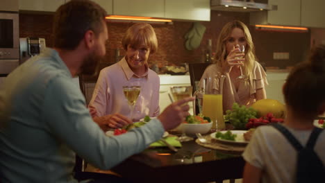 happy family having dinner in kitchen