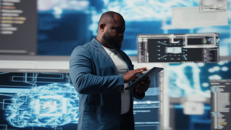 young professional engineer focused on coding with tablet at an innovation hub
