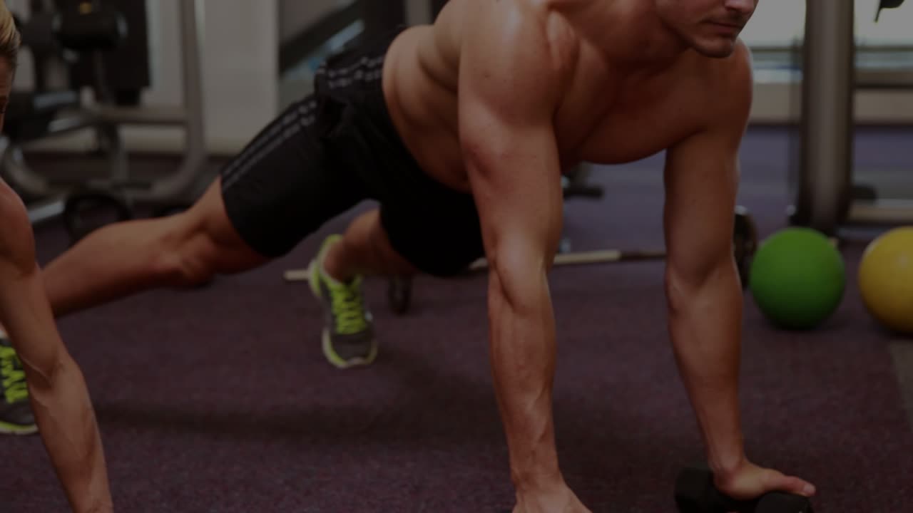 Man and woman performing plank rows on gym floor, initiating financial charts visualizing gains