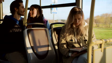 young woman reading in the bus