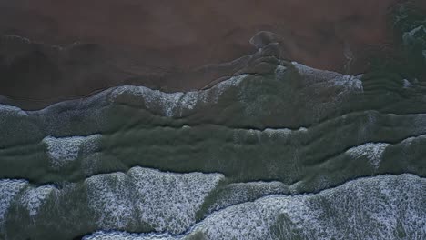 Top-down-aerial-video-with-beach,-waves-and-surf-is-from-Ho-Tram-beach-in-Vietnam