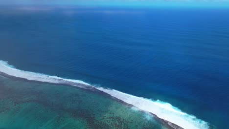 teahupoo tahiti aerial drone view french polynesia channel shallow coral reef wave surf break waves crashing aqua blue pacific ocean sea sunny point faremahora pass havae forward pan down