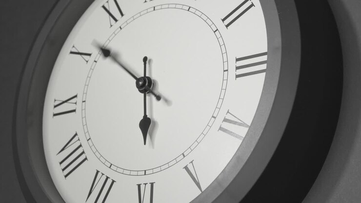 Latin Clock Face in Time Lapse on Dark Grey Wall