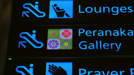 signs for lounges, peranaka gallery, and prayer facility