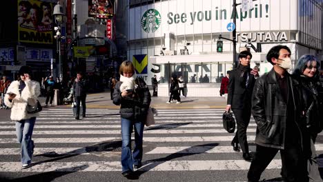 pedestrians crossing at a busy urban intersection