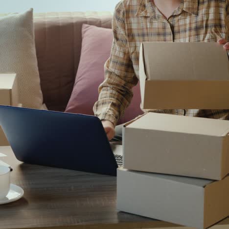 working from home - a woman sorts parcels in her room