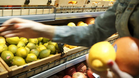 woman's hand chooses fruit and vegetables from a food counter in a supermarket. healthy lifestyle. vegetarianism. proper nutrition.