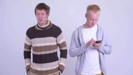 young man farting with young man looking disgusted