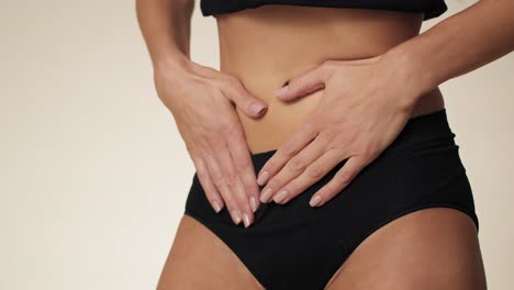 unrecognizable woman in underwear feeling stomachache in lower part of abdomen