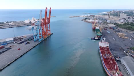 aerial forward view of cranes and containers at haina port in santo domingo, dominican republic