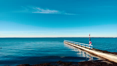 board-walk-on-empty-beach-near-calm-ocean