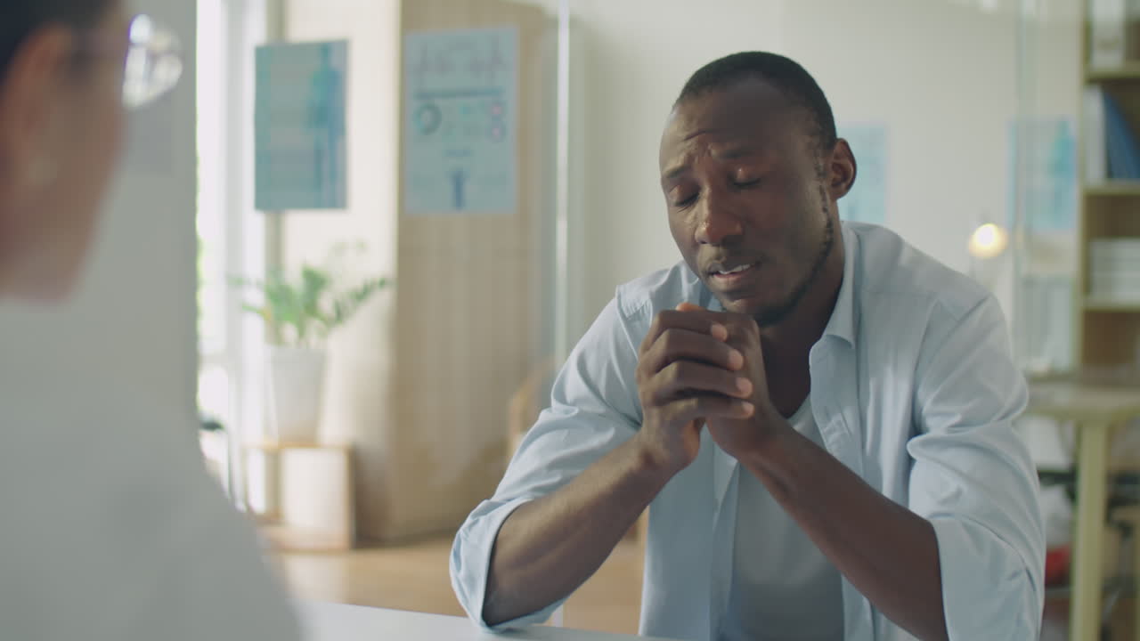 Black Man Complaining about Headache to Doctor