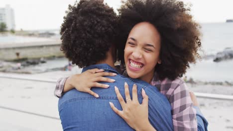 Mujer-Afroamericana-Abrazando-A-Su-Marido-En-El-Paseo-Marítimo-Cerca-De-La-Playa.