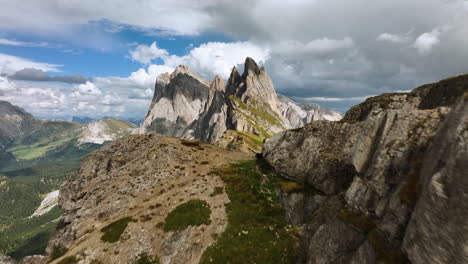 aerial view over cliffs, revealing the seceda ridge, summer day in dolomites, italy