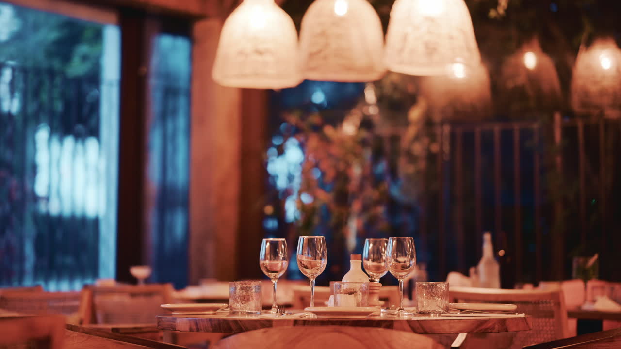 Woman with long wavy hair, viewed from behind as she looks at pastries through the display glass